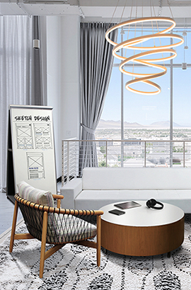 Modern office lounge and collaborative space with low-slung armchair, white sofa, round coffee table, floor-to-ceiling windows with city view, and whiteboard for design sketches.